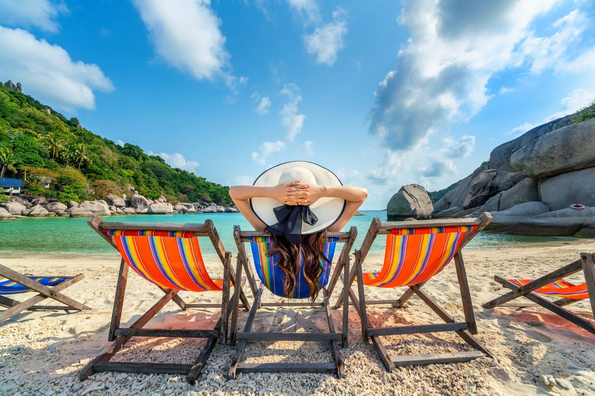 imgi_10_woman-with-hat-sitting-chairs-beach-beautiful-tropical-beach-woman-